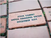  ?? JESSICA HILL /THE NEW YORK TIMES ?? Lydia Gilbert, whose memorial brick is on the town green of Windsor, was one of the women executed as witches in Connecticu­t.