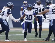  ?? JOHN WOODS/THE CANADIAN PRESS ?? After returning a punt for a TD, Argo Martese Jackson took a kickoff all the way in Winnipeg — only to have it wiped out by a flag behind the play.