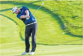  ??  ?? Marc Leishman hits his approach shot on the 18th hole.