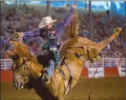  ?? NWA Democrat-Gazette/JASON IVESTER ?? Jacobs Crawley of Boerne, Texas, competes in the saddle bronc Thursday during the Rodeo of the Ozarks at Parsons Stadium in Springdale. Crawley scored 87 on the ride.