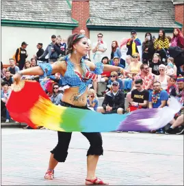  ?? Herald photo by Tim Kalinowski ?? Jenn Fleming-Baker of the Desertwind Belly Dancers play Dorothy in her group’s PrideFest retelling of the "Wizard of Oz" at the Galt Gardens on Saturday.