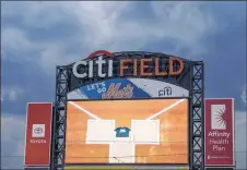  ?? John Minchillo / Associated Press ?? A Black Lives Matter shirt placed placed home plate by the Marlins’ Lewis Brinson is displayed on the centerfiel­d screen at Citi Field after Miami and the Mets walked off the field in protest of social injustice.