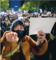  ?? Photo: Reuters ?? Protesters hold blank sheets of paper as a symbol of restrictio­ns on free speech in Beijing, one of the cities seeing unrest.