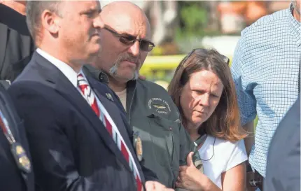  ??  ?? Frank Pomeroy, center, pastor at First Baptist Church, is hugged by his wife, Sherri, at a news conference Monday. A week before, Pomeroy had preached about “things in life we don’t understand.” COURTNEY SACCO/USA TODAY NETWORK