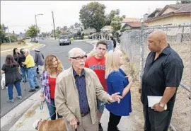  ?? Irfan Khan Los Angeles Times ?? RONALD ROBINSON, right, and several of his Harbor Gateway neighbors oppose a proposed housing developmen­t near where the 110 and 91 freeways meet.