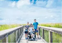  ?? SYLVIA LONGMIRE/COURTESY PHOTO ?? Sylvia Longmire explores a boardwalk with her sons at Paynes Prairie Preserve State Park near Gainesvill­e.