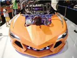  ?? — AFP ?? JAKARTA: A boy admires a special custom-made car on display at the Indonesia Internatio­nal Motor Show in Jakarta yesterday. Indonesia has forecasted vehicle sales in 2017 to reach 1.1 million units, growing at a rate of five percent, as Indonesia’s...