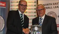  ??  ?? Gerry Gorman (NEFL secretary) makes a presentati­on to retiring NEFL vice-chairman Jimmy Mangan.