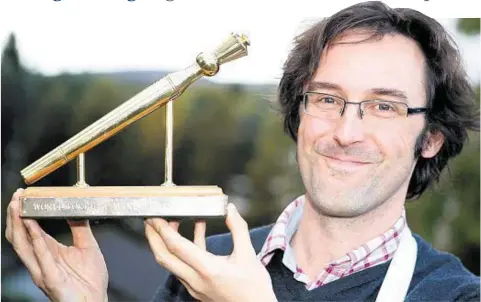  ??  ?? RECIPE FOR SUCCESS: Benedict Horsbrugh proudly displays the Golden Spurtle trophy after his porridge-making triumph