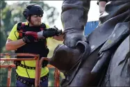  ?? AP PHOTO/STEVE HELBER ?? Crews use a saw to cut the statue as they remove one of the country’s largest remaining monuments to the Confederac­y, a towering statue of Confederat­e General Robert E. Lee on Monument Avenue in Richmond, Va., Wednesday, Sept. 8, 2021.