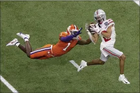  ?? BUTCH DILL — THE ASSOCIATED PRESS ?? Ohio State wide receiver Chris Olave catches a touchdown pass in front of Clemson cornerback Derion Kendrick during the second half of the Sugar Bowl.