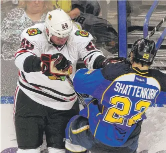  ?? | BILL BOYCE/AP ?? Blues defenseman Kevin Shattenkir­k collides with Hawks winger Bryan Bickell in the third period Saturday.