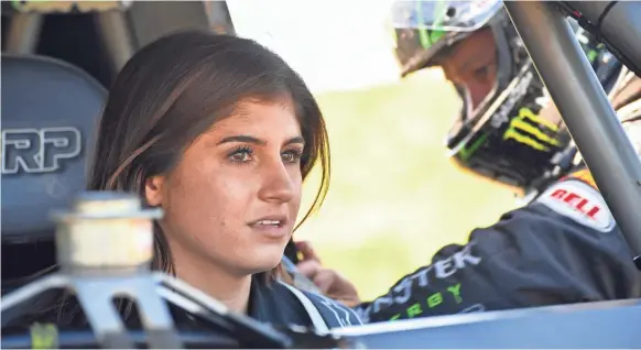  ?? ROBERT HANASHIRO/USA TODAY SPORTS ?? Race-car driver Hailie Deegan listens to her father, Brian Deegan, before taking practice laps on a dirt track near the family’s home.