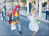  ?? Westside Eagle Observer/SUSAN HOLLAND ?? A line of costumed youngsters follows the numbers as they listen to Halloween music at the Jolly Good Times Extension Club’s cakewalk. Extension Club members offered delicious home-baked goodies as prizes for those who stopped on the correct numbers.