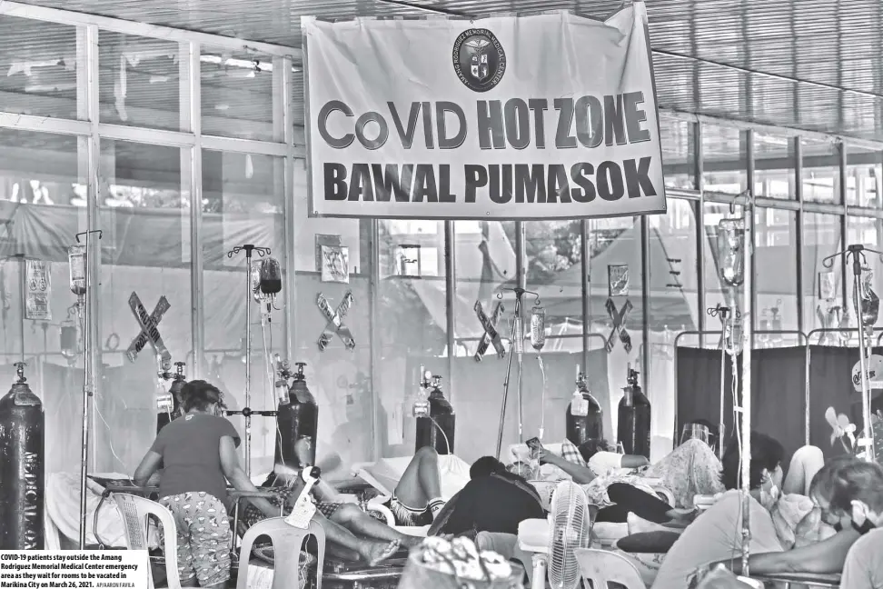  ?? AP/AARON FAVILA ?? COVID-19 patients stay outside the Amang Rodriguez Memorial Medical Center emergency area as they wait for rooms to be vacated in Marikina City on March 26, 2021.