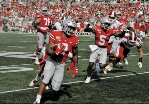  ?? File photo by Mike Frank ?? J. K. Dobbins of Ohio State carries the ball during a game last season against Miami of Ohio. Dobbins and Chase Young have moved to the NFL, but the Buckeyes are expected to contend for a national title.