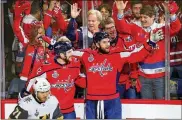  ?? AVI GERVER / GETTY IMAGES ?? Tom Wilson (right) is congratula­ted by Capitals teammate Evgeny Kuznetsov after scoring a first-period goal against Vegas in Game 4 of the Stanley Cup Final on Monday. The Capitals won 6-2.