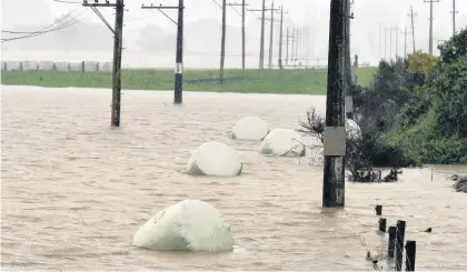  ?? PHOTO: PETER MCINTOSH ?? High water . . . Silage bales float in a paddock on the Taieri during last week’s flooding.