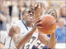  ?? | AP PHOTO ?? Notre Dame’s Jerian Grant (right) defends as Pittsburgh’s Josh Newkirk shoots in the first half on Saturday in Pittsburgh.