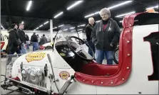  ?? ?? Arlene Ditizio of Hyde Park, whose brother William “Red” Riegel was killed in a race at the fairground­s, looks over a race car at the Reading Fairground­s Racing Reunion Saturday, Feb. 25, at the Classic Auto Mall, 6180 Morgantown Road, Morgantown.