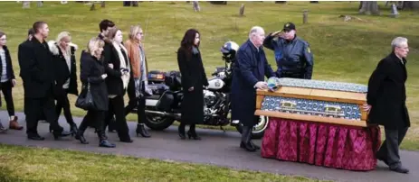  ?? ANDREW FRANCIS WALLACE PHOTOS/TORONTO STAR ?? Relative escort the casket of 7-year-old Evan Leversage at St. George Cemetery in St. George, Ont., on Thursday.