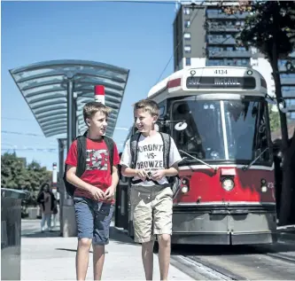  ?? AARON VINCENT ELKAIM/CANADIAN PRESS ?? Connor Cassiotis, left, and his twin brother Wyatt Cassiotis, 10, walk and take public transit to school by themselves.