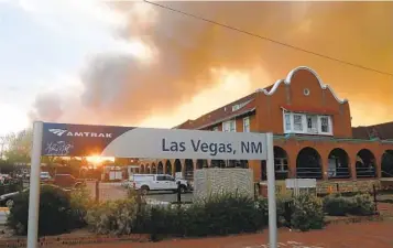  ?? CEDAR ATTANSIO AP ?? A wildfire burns in Las Vegas, N.M., on Saturday. The city remained largely safe from the flames after some residents were allowed to return over the weekend. Schools were set to return to in-person classes today.