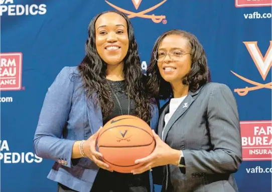  ?? ERIN EDGERTON/THE DAILY PROGRESS ?? Virginia women’s coach Amaka Agugua-Hamilton, left, poses with athletic director Carla Williams on June 22 in Charlottes­ville, Va. The ACC and SEC have led the way among the power conference­s in hiring coaches of color to lead women’s hoops programs.