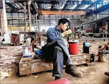  ?? HOANG DINH NAM/AFP ?? A factory worker takes a break at the Gia Lam factory in Hanoi on May 10.