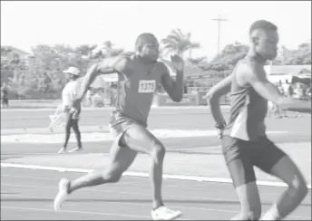  ??  ?? Action in the Male Teachers (Under-31) 4x100m relay heats which was won by District 13. District 13’s Ian Campbell is pictured powerfully striding during the first hand over. (Emmerson Campbell photo)