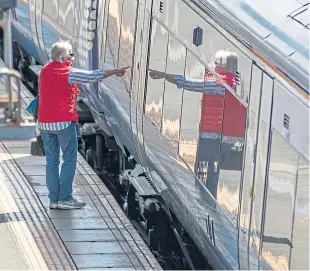  ?? Picture: Kim Cessford. ?? A masked passenger boards a train at Inverkeith­ing.