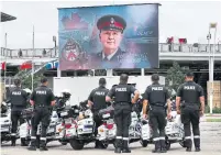  ?? RICHARD LAUTENS TORONTO STAR FILE PHOTO ?? Motorcycle officers watch Det. Const. Jeff Northrup’s July 12 funeral service on a screen outside BMO Field.