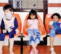  ??  ?? Three kids wait for their parents at the hospital in Kozhikode.