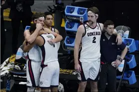  ?? DARRON CUMMINGS - THE ASSOCIATED PRESS ?? Gonzaga forward Corey Kispert (24) hugs Jalen Suggs (1) as Gonzaga forward Drew Timme (2) looks on at the end of the championsh­ip game against Baylor in the men’s Final Four NCAA college basketball tournament, Monday, April 5, 2021, at Lucas Oil Stadium in Indianapol­is. Baylor won 86-70.