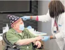  ?? SETH HARRISON/USA TODAY NETWORK ?? Nurse Starlena Moore greets Allan Lesser, 88, who’s come to be vaccinated against COVID-19 at the offices of YAI in New York City.