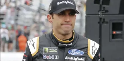  ?? AP PHOTO/MARY SCHWALM ?? Aric Almirola smiles as he walks to his race car after being introduced before the start of the NASCAR Cup Series auto race on Sunday, at New Hampshire Motor Speedway in Loudon, N.H.