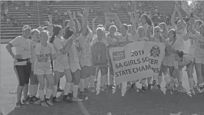  ?? TONY LENAHAN/THE Saline Courier ?? Bryant Lady Hornets soccer Coach Nicole Inman, far left, celebrates the 6A State Tournament championsh­ip with her team last month at Razorback Field in Fayettevil­le. Inman earned the AHSCA Coach of the Year.