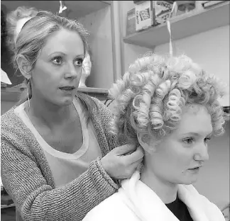  ?? WARD PERRIN/ VANCOUVER SUN ?? Stacey Butterwort­h (left) works on Kelly Metzger's wig for opening night of A Little Night Music.