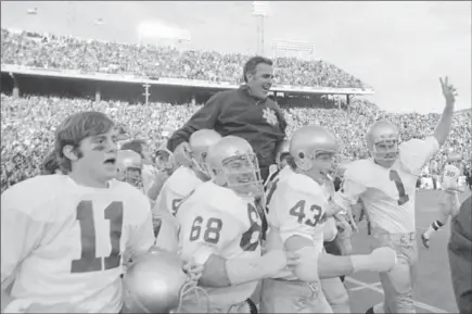  ?? ASSOCIATED PRESS FILE PHOTO ?? Notre Dame coach Ara Parseghian is carried off the field by his players after defeating Texas, 24-11, in the Cotton Bowl on Jan. 1, 1971.