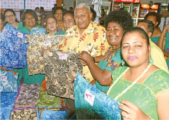  ?? Photo: Ronald Kumar ?? Prime Minister Voreqe Bainimaram­a with members of Ba Women’s Forum following the launch of reusable cloth shopping bags at RB Patel Centerpoin­t, Laucala Beach on August 1, 2017.