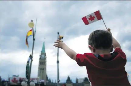  ?? ASHLEY FRASER ?? Flag-wavers of all ages celebrated our country’s 149th birthday at Canada Day festivitie­s downtown on Friday.