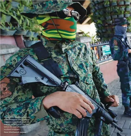  ?? Photo: Epa/francis R. Malasig ?? Check point: An elite armed unit of the Philippine police stops a motorist in Las Pinas, south of Manila, on March 14, one day before the start of a month-long localized lockdown.