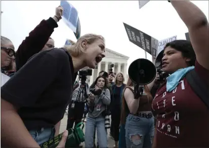  ?? PHOTO BY ANNA MONEYMAKER — GETTY IMAGES ?? Pro-choice and anti-abortion activists yell at one another in front of the U.S. Supreme Court Building on May 03, 2022in Washington, D.C.