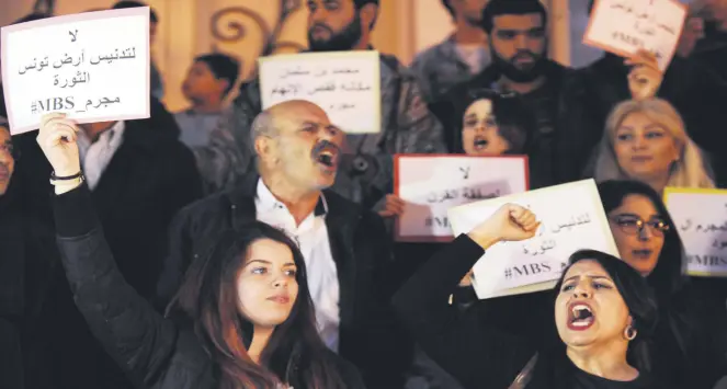  ??  ?? Protestors hold placards reading in Arabic “no to the desecratio­n of Tunisia, the land of the revolution” during a protest against the visit of MBS in Tunis, Tunisia, Nov. 26.