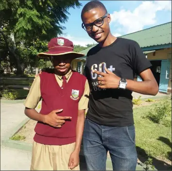  ??  ?? Dereck Mpofu with one of Murewa High school pupils