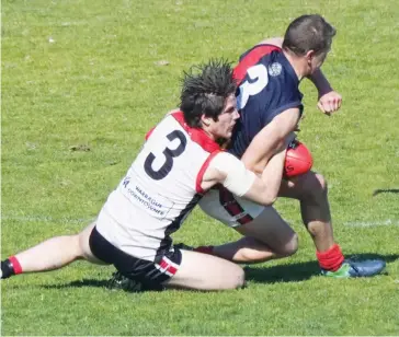  ??  ?? Two of the better players for their respective sides at Western Park on Saturday, on-ballers Kim Drew (Warragul) laying a tackle on Bairnsdale’s Russell Cowan as the sides fought out a close struggle all game, Bairnsdale holding on to win by three points.