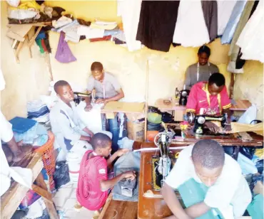  ??  ?? Tailors busy at Salisu Adam area, Jos North
