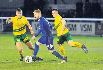  ?? Pics: Arwyn Roberts ?? ● Marc Williams up against Jamie Crowther and his Canaries team-mate Cai Jones