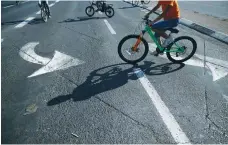  ?? (Ammar Awad/Reuters) ?? CHILDREN RIDE their bicycles on a car-free Jerusalem road on Yom Kippur.