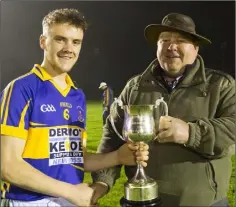  ??  ?? Barry Kelly receives the cup from P.J. O’Farrell.